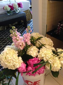 Another work bucket and 2 completed arrangements on the bench in background.